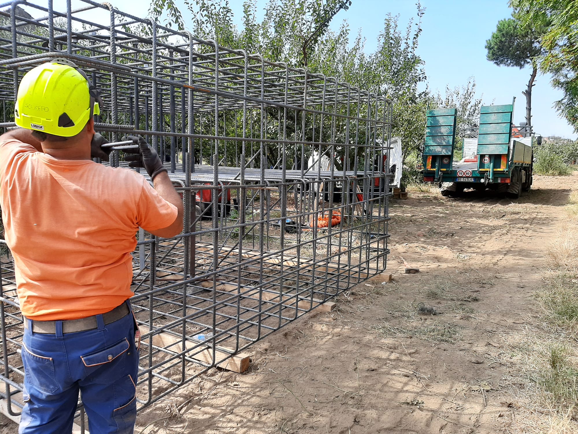 Construction worker beside steel reinforcement